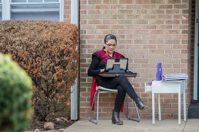Mexican journalist Perla Lara sits at her work area outside her apartment, trying to get the next issue of Impacto out to press.