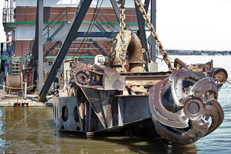 The cutting blade of the dredge is lifted for maintenance of the motor system underdeck of the Norfolk Dredging Co. ship Thursday on the Delaware River, 1.5 miles East of Delaware City, Del. (David M Warren / Staff Photographer)