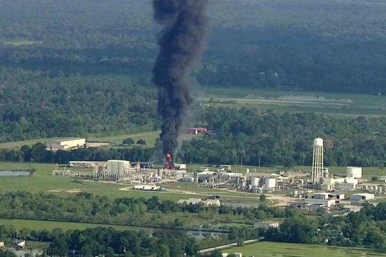 In this September 2017 file photo, smoke rises from an Arkema chemical plant in Crosby, Texas, near Houston, as 17 tons of volatile organic phosphates burn following power and refrigeration systems failures under 40 inches of rain from Hurricane Harvey. The French-owned company's U.S. headquarters is in King of Prussia. Arkema North America and its CEO, chief logistics officer, and a plant manager are contesting criminal charges in Harris County, Texas. They say politically motivated prosecutors are unfairly blaming them for an "act of God." (KTRK via AP, File)
