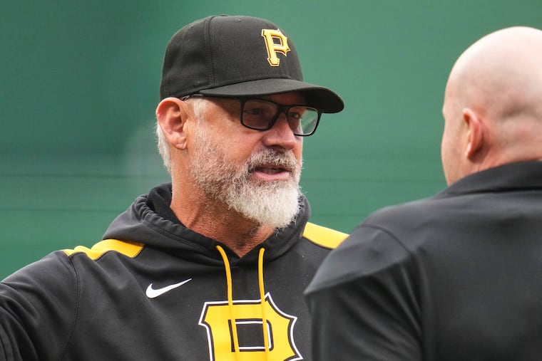 Pirates manager Derek Shelton talking with umpire Mike Estabrook during a game against the San Diego Padres on May 3.