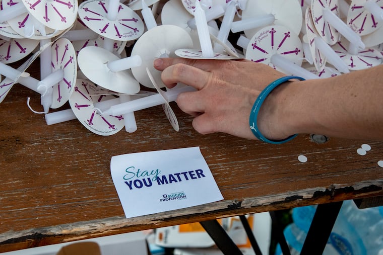The community gathers for a "Lights of Hope" candlelight vigil n Downingtown, June 6, 2021, to remember students lost by suicide.