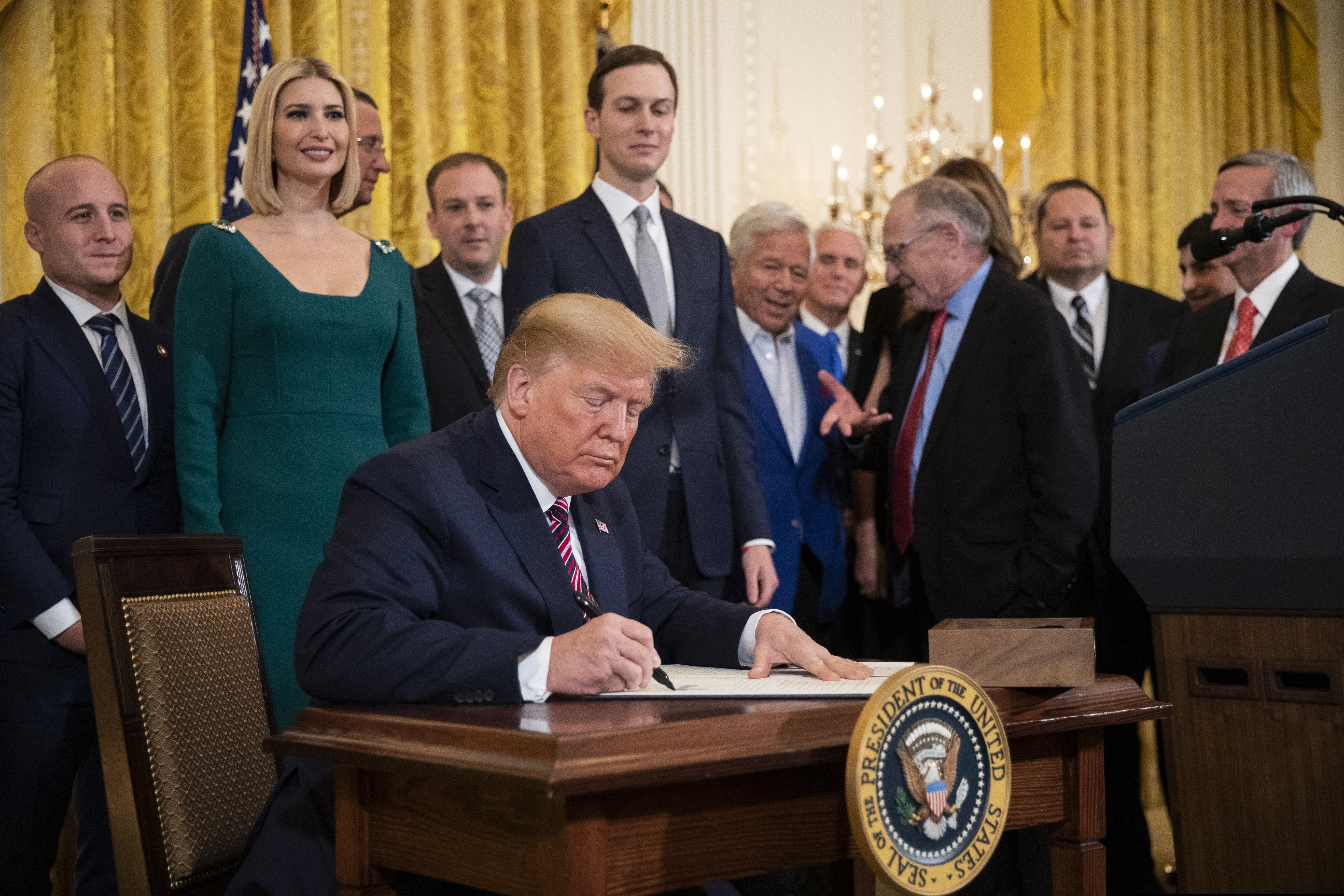President Donald Trump signs an executive order combating anti-Semitism in the U. S. during a Hanukkah reception in the East Room of the White House.