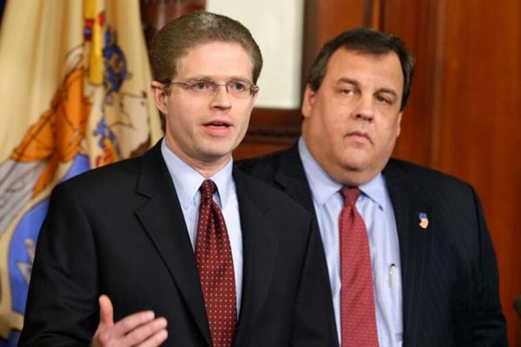 New Jersey Gov. Chris Christie, right, listens as New Jersey state comptroller Matthew Boxer answers a question Friday, Feb. 8, 2013, in Trenton, N.J., after Christie announced an executive order for monitors on the spending for Superstorm Sandy aid. Earlier this week, Christie defended the hiring of AshBritt Inc. in a $100 million debris removal contract that was not competitively bid. New Jersey piggybacked on an earlier contract that the state of Connecticut negotiated with the company, which is allowed. (AP Photo/Mel Evans)