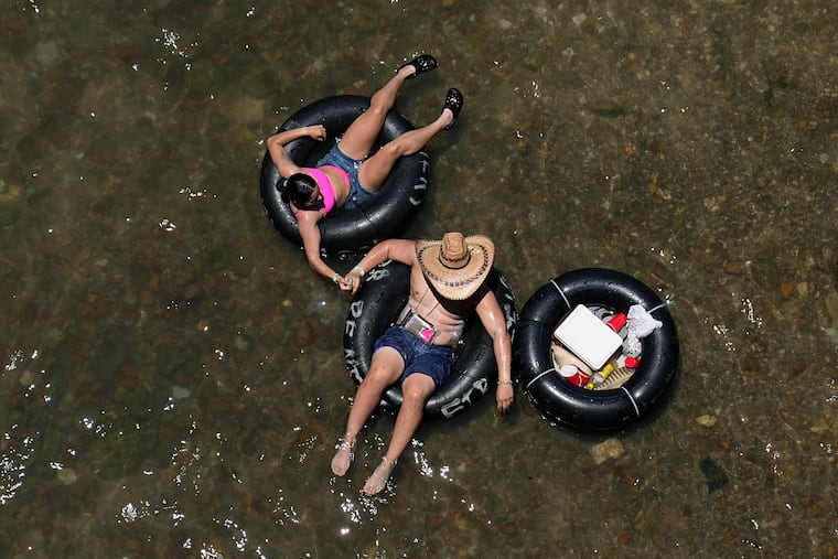 Tubers float the Comal River in New Braunfels, Texas, on Thursday.