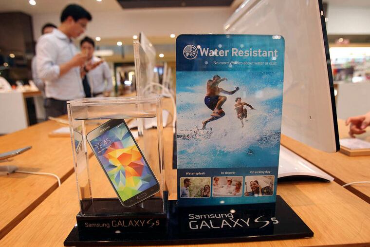 A Samsung smartphone is displayed at the company's showroom in Seoul, South Korea. Samsung Electronics Co., the world's biggest smartphone maker, reported a bigger-than-expected fall in quarterly profit Thursday. Marketing costs for its smartphones rose as Samsung tries to fend off competition from Apple and Chinese producers. Net income, excluding minority interests, fell 18 percent to $6 billion in the three months ended in June.
