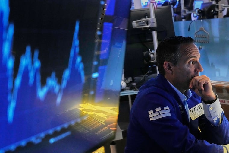 Specialist Michael Gagliano works at his post on the floor of the New York Stock Exchange in June. (AP Photo/Richard Drew)