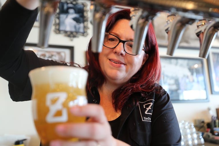 Lori White, co-owner of Zed's Beer in Marlton, pours a beer at the brewery. It's not clear whether currently suspended rules guiding how breweries in New Jersey operate will be re-instated in the new year. Under current law, breweries in the state are not allowed to have kitchens, cannot serve soft drinks or coffee, and can host only 25 events per year.