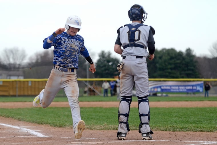 Northern Burlington's Tyler O'Dell crosses the plate, scoring on pitcher Zach Gakeler's fourth inning two-run, two-out single. Township catcher is David Viselli. (Tom Gralish/Staff Photographer)