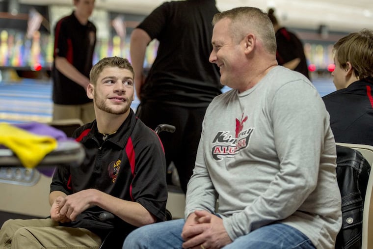 Josh Everwine (left) is joined by his father, Chris, as he participates for Kingsway in his first varsity bowling match.