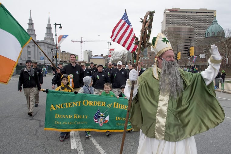 John Cooke, dressed at St. Patrick, leads members of the Ancient Order of Hibernians Div. 1 Dennis Kelly out of Havertown around Logan Circle and up the Ben Franklin Parkway during Philadelphia's annual St. Patrick's Day Parade March 13, 2016.