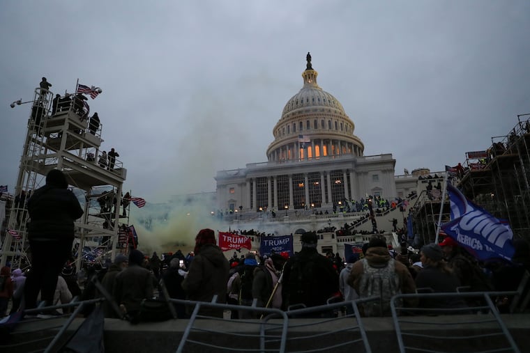Smoke can be seen outside of the U.S. Capitol on Jan. 6, 2021, as supporters of Donald Trump storm the building in a failed attempt to overturn the 2020 election results.