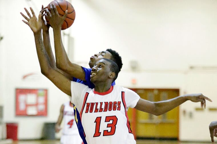Simon Gratz's Nasir Campbell (13) and Ben Franklin's Isaiah Wilmore battle for a second-quarter rebound on Thursday, Jan. 14, 2016.