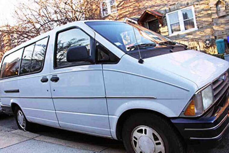 The van with a flat tire parked on Fern Street. (Rachel Gouk / Staff Photographer)