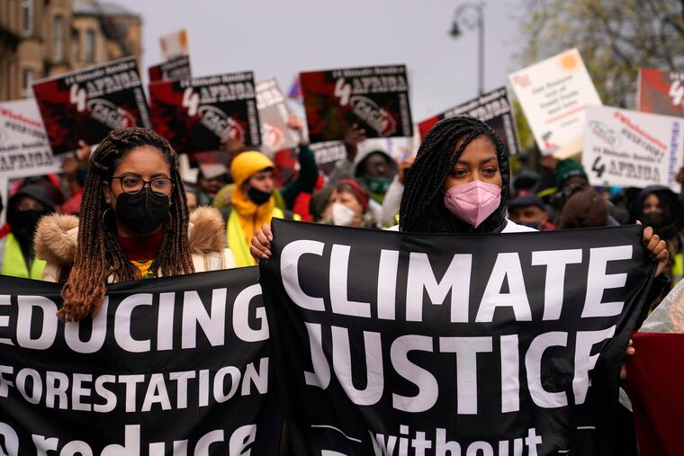 Climate activists hold up banners during a protest organized by the Cop26 Coalition in Glasgow, Scotland, Saturday, Nov. 6, 2021 which is the host city of the COP26 U.N. Climate Summit. The protest was taking place as leaders and activists from around the world were gathering in Scotland's biggest city for the U.N. climate summit, to lay out their vision for addressing the common challenge of global warming.