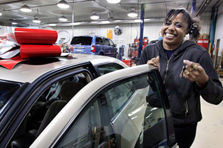 Beth Douglas of Sewell gets into her refurbished 1999 Toyota Camry at Boggs Auto Collision Rebuilders in Woodbury. (Elizabeth Robertson/Staff Photographer)