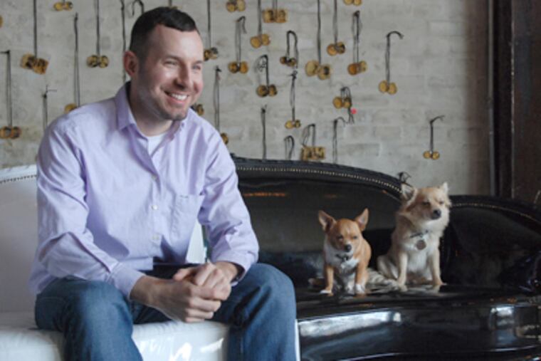Kevin Derrick, interior designer for Bahdeebahdu in South Kensington, sits on a hand-carved, patent-vinyl Victorian Sofette. Derrick redesigned the sofa, which he found dumpster-diving in Brooklyn. (Amanda Cegielski / Staff Photographer)