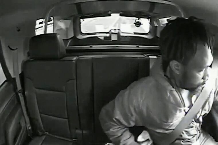 In this image taken from May 23, 2020, video released by the New Jersey Attorney General's Office, Maurice Gordon, of Poughkeepsie, N.Y., he unbuckles his seatbelt before exiting a New Jersey State trooper's vehicle in Bass River, N.J. Gordon was fatally shot by the state trooper.