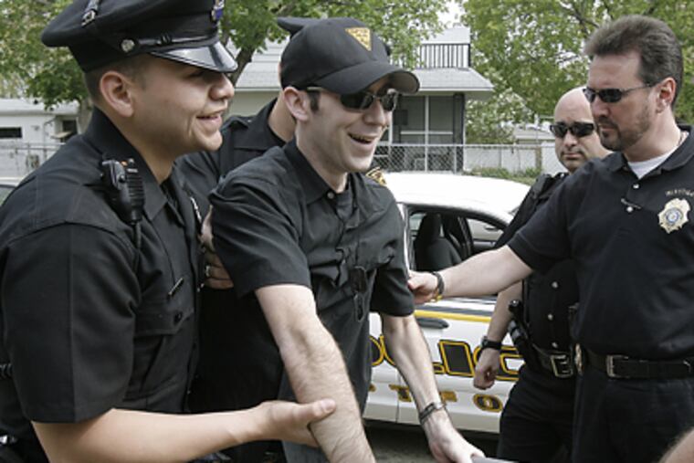 With an assist from fellow officers, Patrolman Gary W. Wurst makes his way home after an April visit to Magee Rehabilitation Center. (Akira Suwa / Staff Photographer)