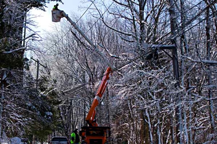 Linesmen work to restore electrical power, Friday, Feb. 7, 2014, in Downingtown, Pa. A small army of electricity restoration crews labored Friday to reconnect about 330,000 customers in Pennsylvania and Maryland. (AP Photo/Matt Rourke)