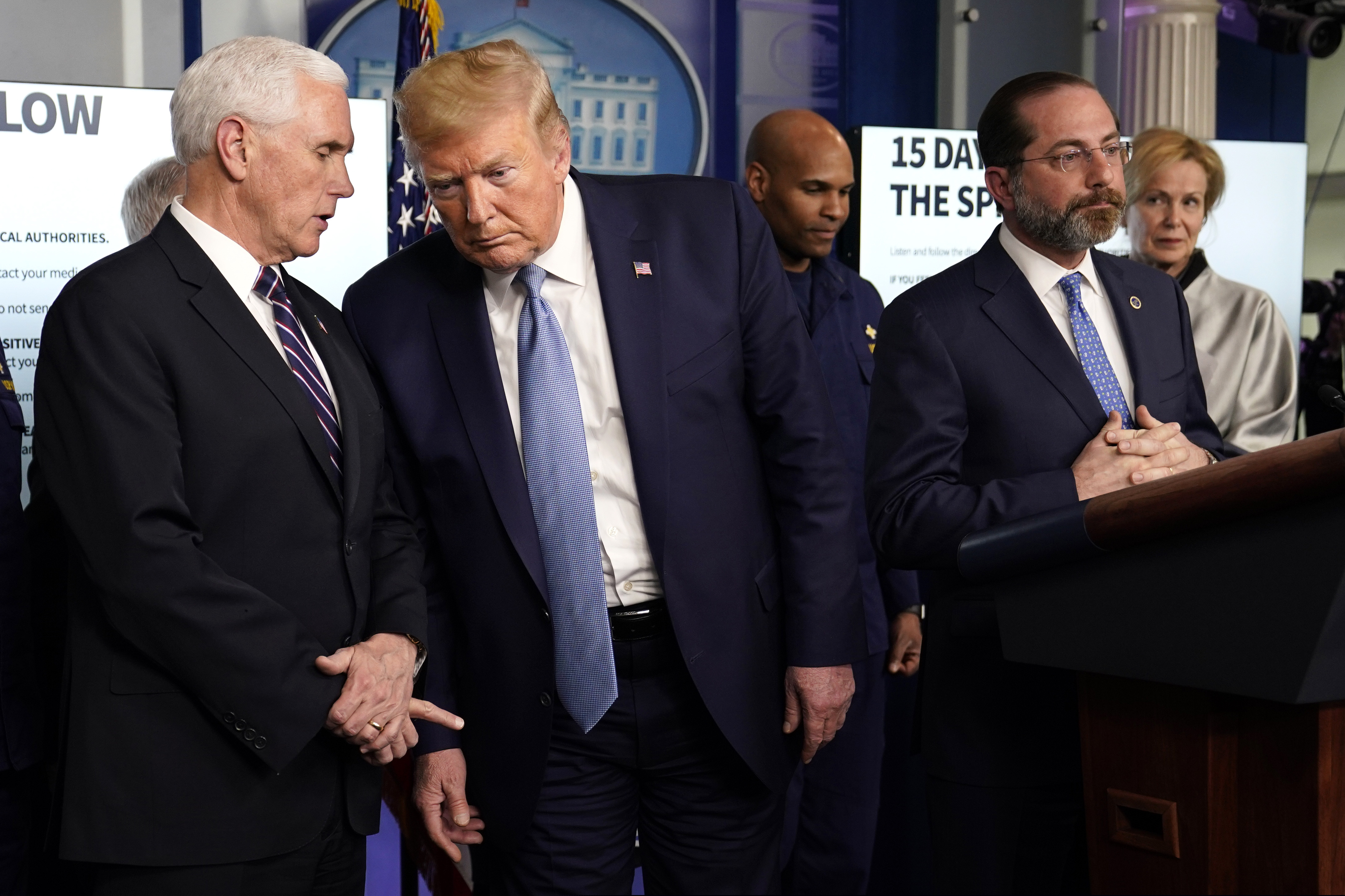 President Donald Trump listens to Vice President Mike Pence, left, as Health and Human Services Secretary Alex Azar speaks during a press briefing with the coronavirus task force, in the Brady press briefing room at the White House, Monday, March 16, 2020, in Washington.