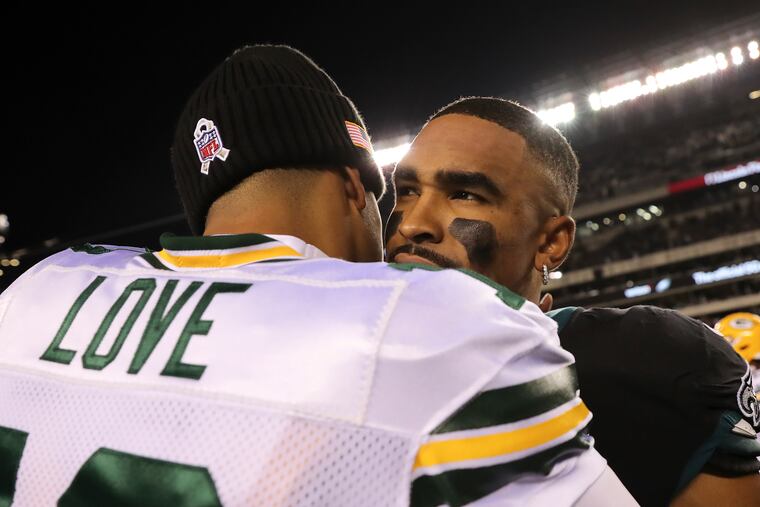 Eagles quarterback Jalen Hurts meets with Green Bay Packers quarterback Jordan Love after the Eagles beat the Packers, 40-33, on Sunday.