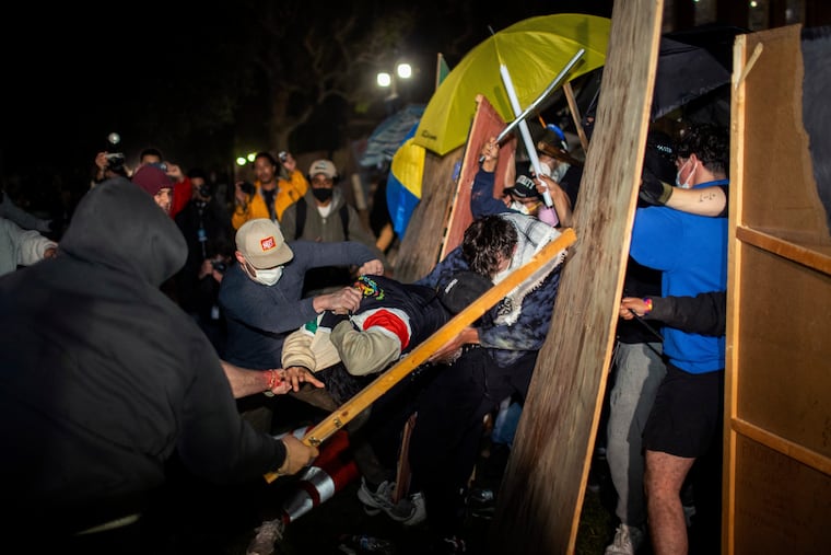 Demonstrators clash at a pro-Palestinian encampment at UCLA early Wednesday in Los Angeles.