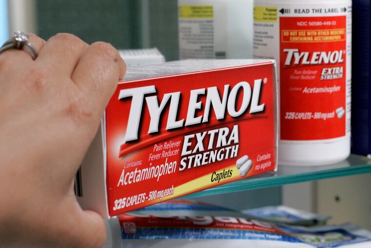 Tylenol Extra Strenth is shown in a medicine cabinet.