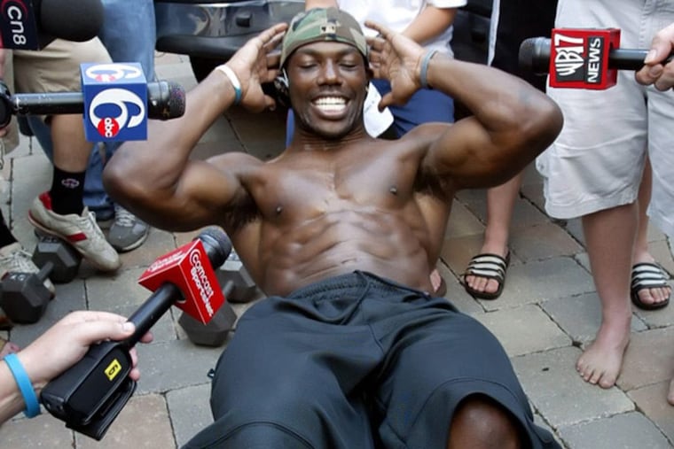 Terrell Owens, banished from training camp for insubordination in 2005, does sit-ups at his home in Moorestown, N.J. for the assembled media.