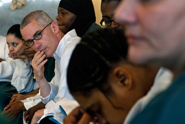Former New Jersey Gov. Jim McGreevey listens as he sits with a group of inmates gathered at Integrity House, at the Hudson County Correctional Center. (Mel Evans / Associated Press)