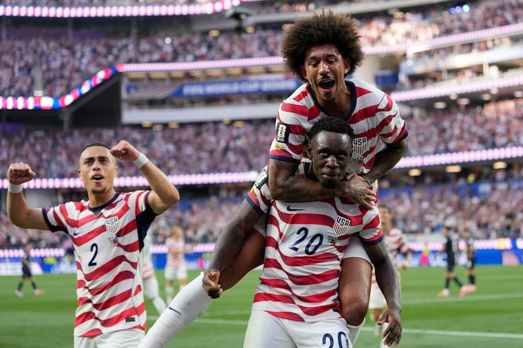 Folarin Balogun (center) celebrates with teammates after scoring one of his goals for the U.S. against Paraguay.
