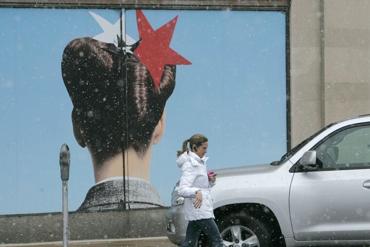 A shopper returns to her car in front of the Macy's in Suburban Square in Ardmore. The store had been the center's largest tenant since 2006.