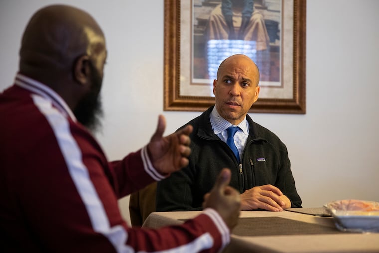 Simian Paulk, 50, of Camden, N.J., talks about his experience in the criminal justice system and his transition back to the community with United States Senator Cory Booker inside his home on Feb. 29, 2020. Paulk is one of the first from New Jersey released under the “First Step Act” that Booker help get passed. “I’m nobody, but he is showing that he cares,” Paulk said. “He’s going beyond and above the limits of helping people. I respect the man to the upmost.”