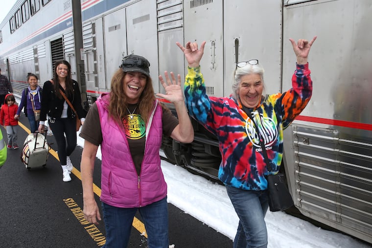 Patricia Bailey (center) and Annette Saba celebrate as they disembark an Amtrak passenger train in Eugene, Ore., Tuesday, Feb. 26, 2019. The train traveling from Seattle to Los Angeles with 183 passengers got stranded in the snowy mountains of Oregon for at least 36 hours, putting a strain on passengers as food, patience, and even diapers ran short.