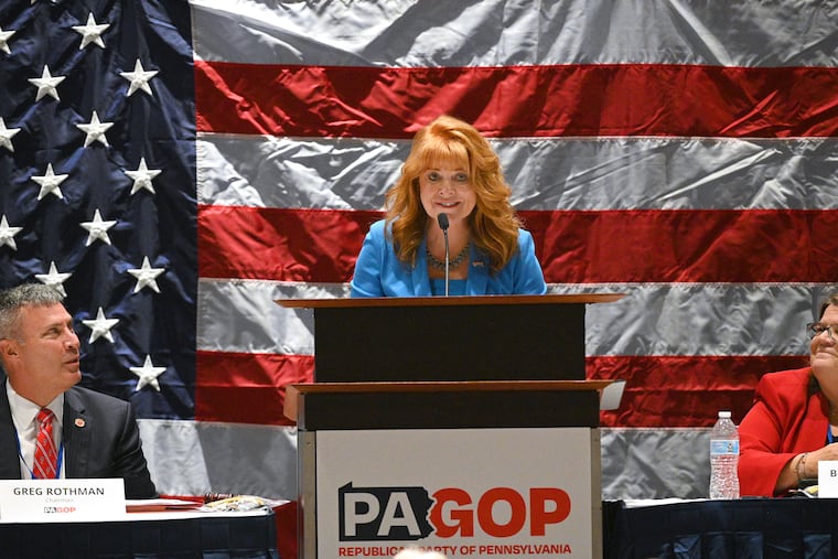 Pennsylvania Treasurer Stacy Garrity gives her acceptance speech after receiving the PA GOP's endorsement for her campaign for governor as Pa. GOP Chairman State Sen, Greg Rothman and Pa. GOP Vice Chair Bernie Comfort look on during The Republican Party of Pennsylvania's 2025 Fall Meeting at The Penn Stater Hotel & Conference Center in State College, Pa., on Sept. 20, 2025.