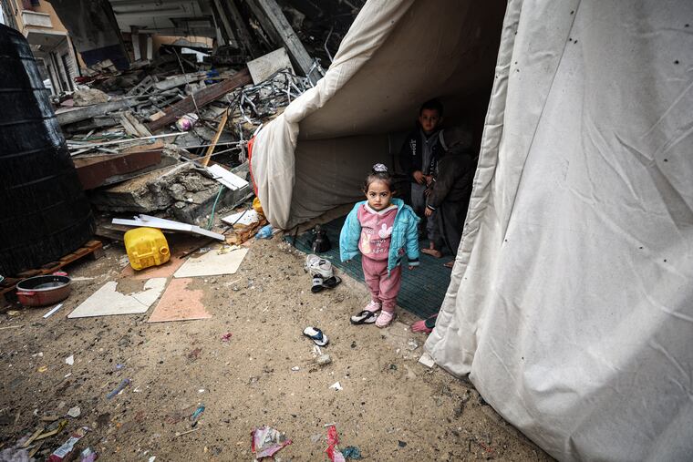 A Palestinian family lives in a tent above their destroyed house in Rafah.