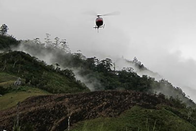 A helicopter comes to pick up the team of biological researchers at La Grande Colline in Haiti. (Joel Timyan)