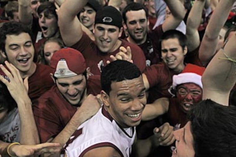 Chris Wilson of St. Joe's gets surrounded by students after beating Creighton on Saturday. (Michael Bryant/Staff Photographer)