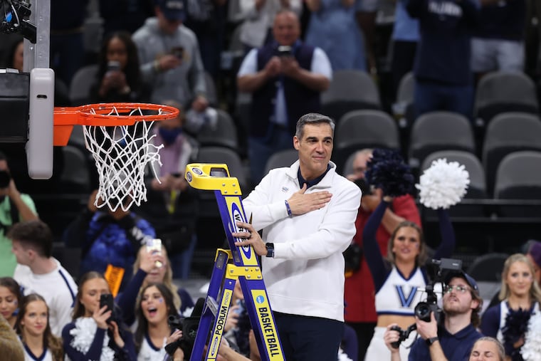 Former Villanova coach Jay Wright turns towards fans with his hand over his heart before taking his turn at cutting the net as the Wildcats celebrate advancing to the Final Four in 2022.
