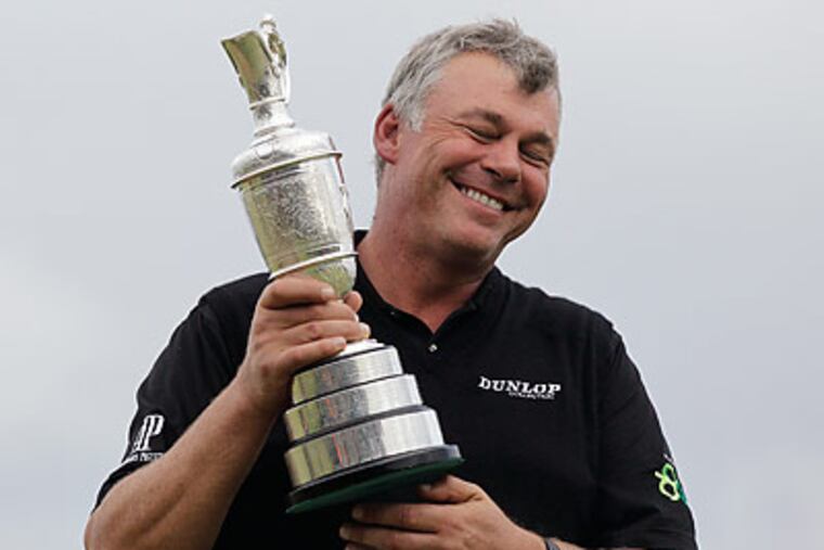 Darren Clarke poses with the Claret Jug after winning the British Open at Royal St. George's. (Matt Dunham/AP)
