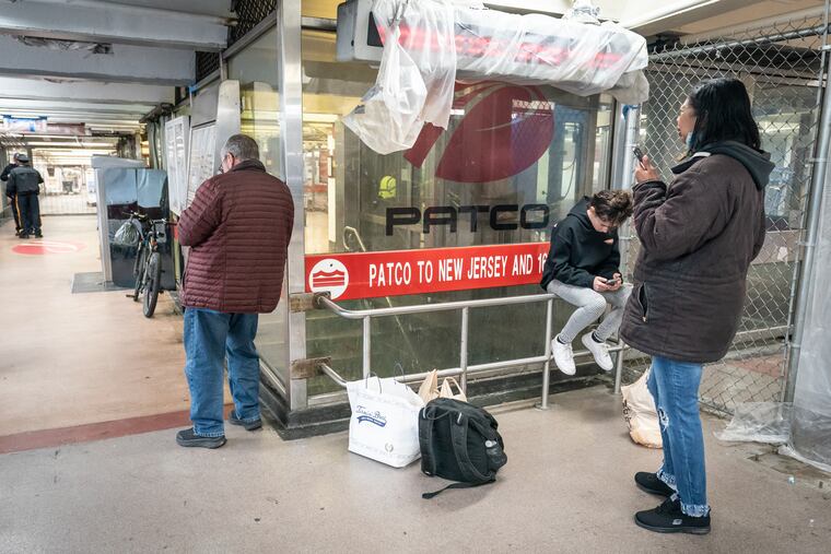 People wait at the 8th and Market PATCO station after PATCO service was suspended following the earthquake.