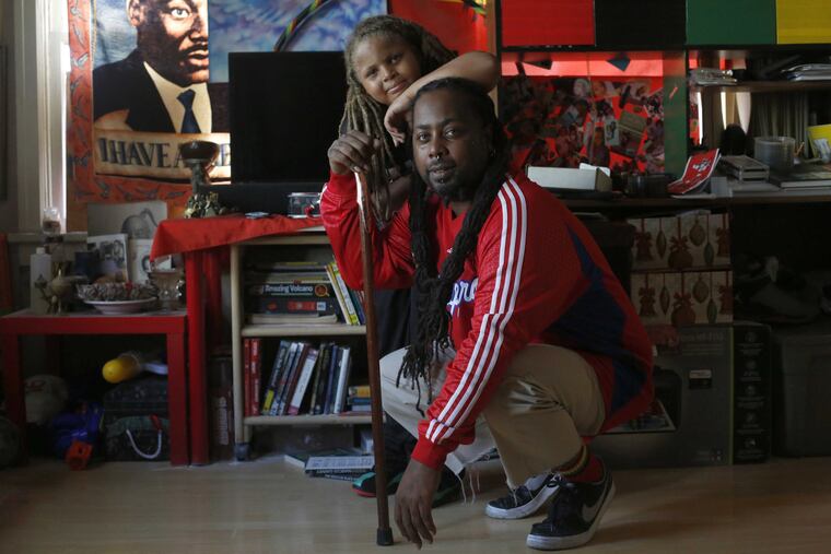 Kenneth Berry, 41, with his 10-year-old son, Keing, in Los Angeles in September. Mr. Berry, who was shot more than 20 years ago, has struggled
with pain since. A Medicaid card has brought him more treatment.