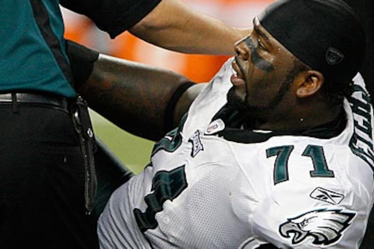 Eagles offensive lineman Jason Peters is tended to by the training staff in the first half yesterday. (David Maialetti / Staff Photographer)