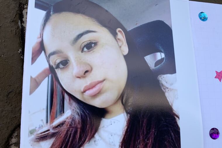 A photo of Crystal Roman-Benitez on display outside the house on the 2500 block of Ninth Street where police say she was killed by stray bullets.