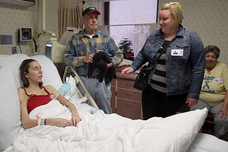Linda Belz , who has ovarian cancer, is trying to raise enough money to pay for her own funeral. Here, she is with her father, Bob Belz, friend Jenn Szewczak and her mother, Sue Belz, at Vitas Hospice. (Yong Kim/Staff)