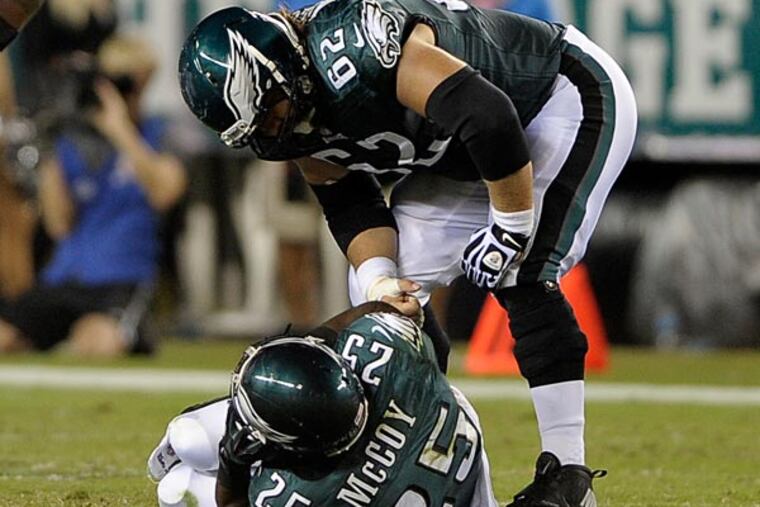 Philadelphia Eagles' Jason Kelce (62) checks on LeSean McCoy after McCoy was injured during the first half of an NFL football game against the Kansas City Chiefs, Thursday, Sept. 19, 2013, in Philadelphia. (AP Photo/Michael Perez)
