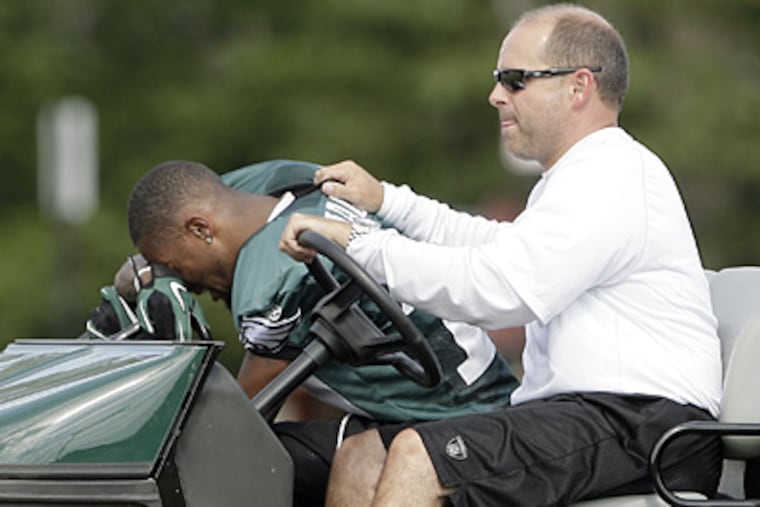 DeSean Jackson (left) gets carted off the field after getting hurt during practice on Saturday. (Yong Kim / Staff Photographer)