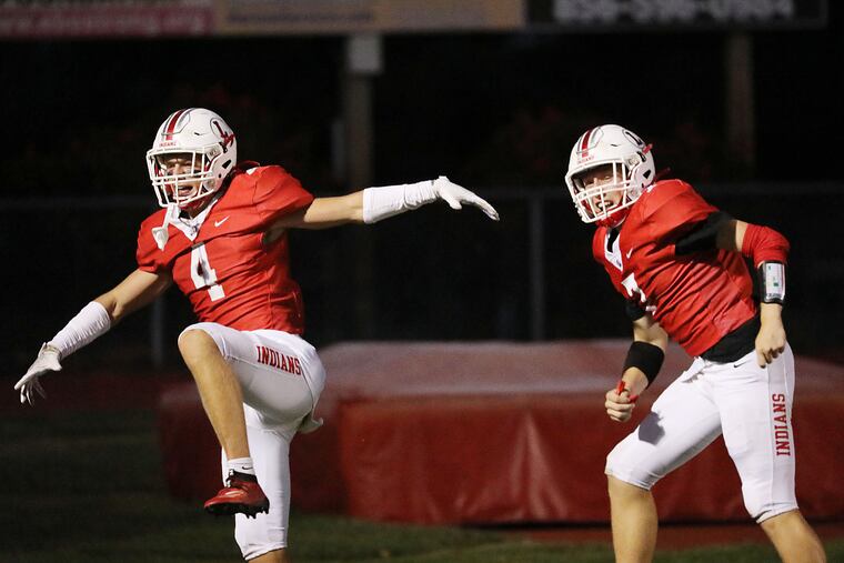 Connor Kennedy (left) and Brady Long celebrate a touchdown pass in Lenape's 20-7 win over St. Augustine on Friday night.