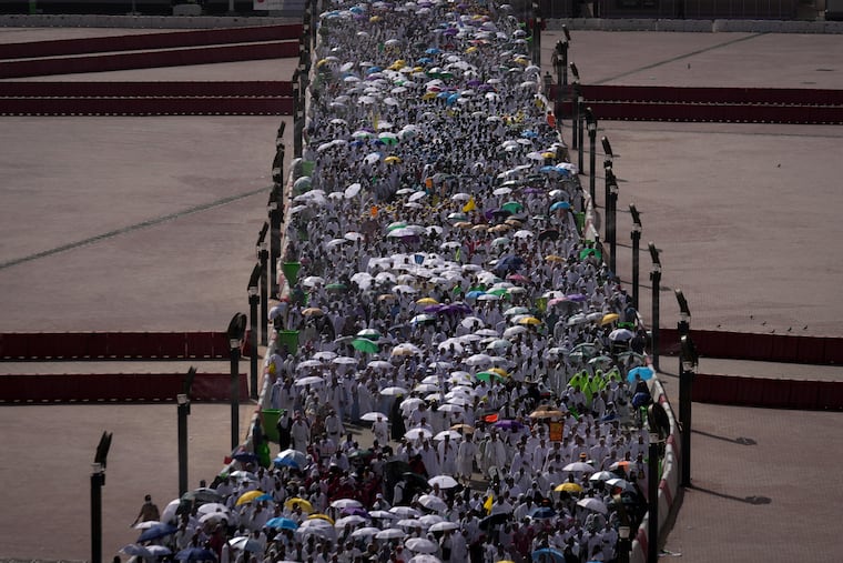 Muslim pilgrims walk on their way to cast pebbles at pillars in the symbolic stoning of the devil, the last rite of the annual Hajj, in Mina near the holy city of Mecca, Saudi Arabia, Wednesday, May 27, 2026. (AP Photo/Altaf Qadri)