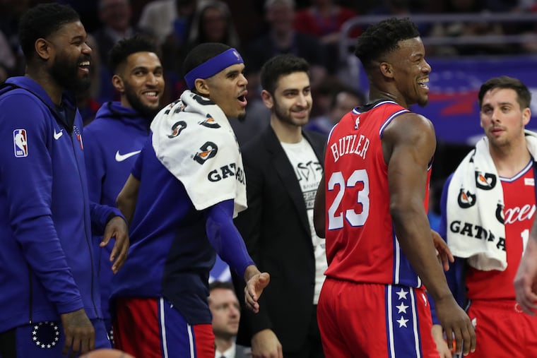 Sixers forward Jimmy Butler laughs with his teammates after a failed dunk attempt after the whistle in the second quarter of a game against the Sacramento Kings at the Wells Fargo Center in Philadelphia on Friday, March 15, 2019.