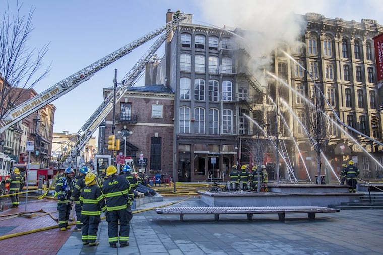 Philadelphia Firefighters use water hoses to attack the latest fire in Old City, which started in an apartment building on the 200 block of Chestnut Street,